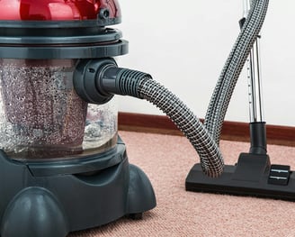 a vacuum cleaner is sitting on the carpet