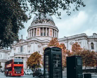a red bus and a red bus in front of St. Paul's Cathedral London
