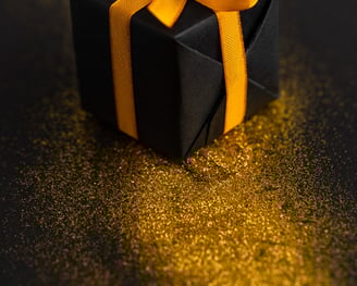 a black box with a yellow ribbon tied to it