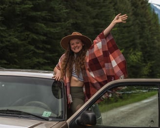 A band elopement photographer waving from a car