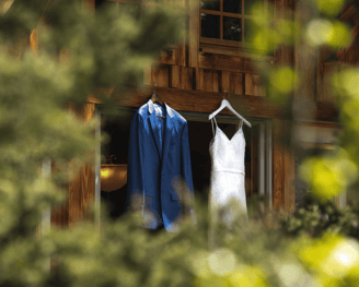 a wedding dress hanging on a cabin