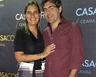 a man and woman standing in front of a backdrop of a backdrop of a backdrop