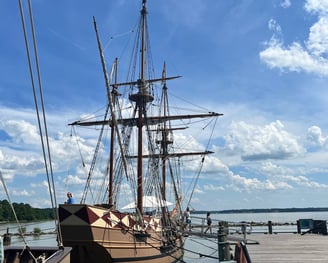 a boat docked at a dock with a boat in the water