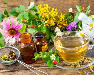 a cup of tea and a teapot with flowers