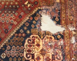 moth holed damaged rug