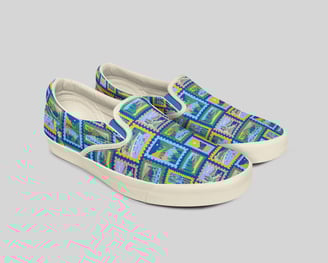 a pair of shoes with a colorful pattern of mountains on the top