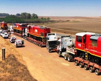 a train is being loaded with a trailer