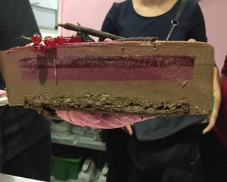 a piece of cake with a chocolate cake on it