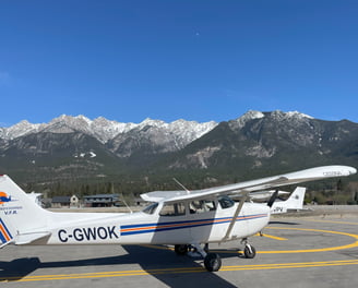 Picture of C-GWOK, a C172 with a backdrop consisting of beautiful mountains of BC