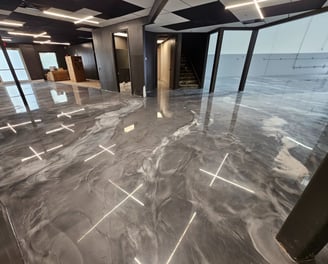 silver, black, and white metallic epoxy flooring in a showroom