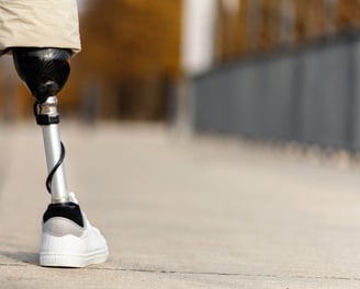 a person with a prosthetic kneel wearing a pair of knee - high