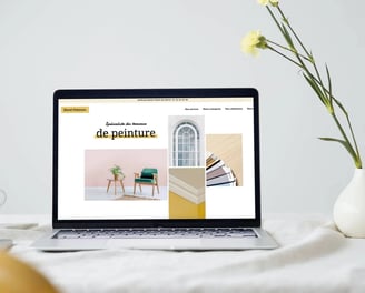 a laptop computer screen displaying a websitepage with a picture of a desk with a