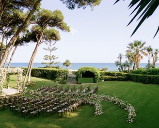 Destination wedding setup and altar in the seaside gardens of Villa El Rincon in Marbella