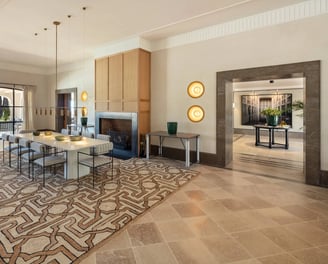 Dining room at Villa La Gratitud with fireplace, modern lighting, and terrace views toward the sea.