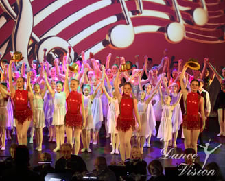 a group of young children and adults performing a musical performance