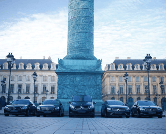 a group of cars parked in vendome place paris