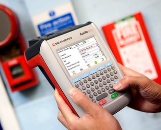 a person holding a portable appliance tester