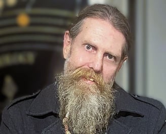 a bearded man posing