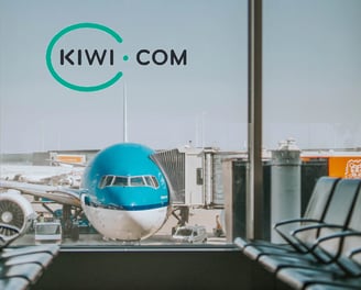 a blue and white airplane sitting in front of a window