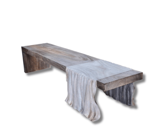 a wooden bench with a blanket draped over it