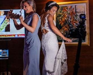 Bride and Maid of Honor standing on a 360 video booth