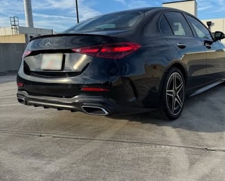 Rear view of black Mercedes C300 luxury sedan with LED tail lights