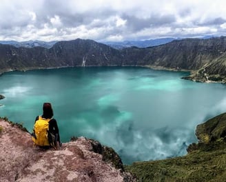 hiker admiring Quilotoa crater lake
