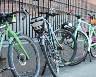 Bikes leaned up against a fence