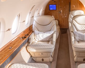 Hawker 800XP cabin interior with luxury leather seating and ambient lighting