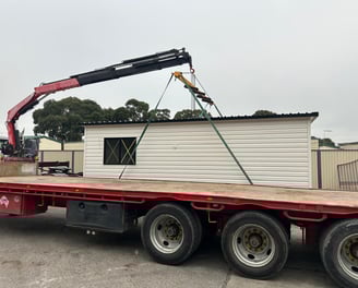 crane lifting potable house