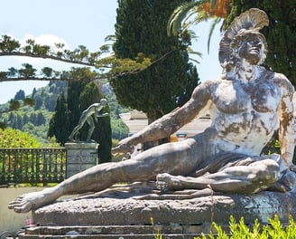 a statue of a man sitting on a stone steps