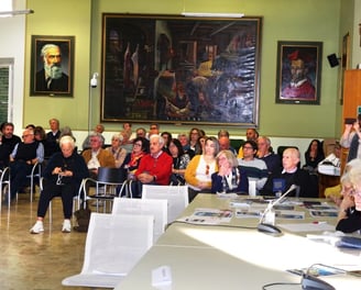 a group of people sitting at tables in a room