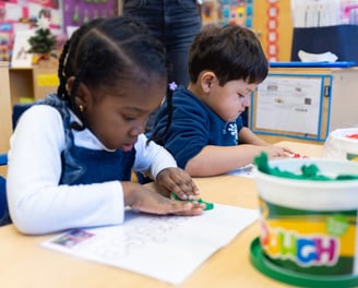 PreK students using playdough mats to develop fine motor skills.
