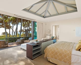 Master suite at Villa El Rincon in Marbella, offering unobstructed views of the gardens and the sea.