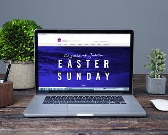 Laptop screen displaying Jubilee Community Church’s website with an Easter Sunday event banner.