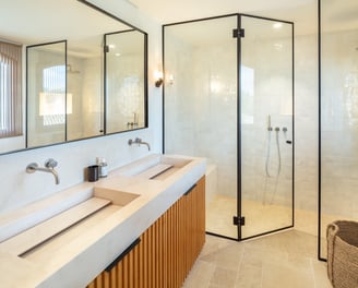 Modern bathroom with double vanity, walk-in rain shower, and natural light at Villa La Gratitud.