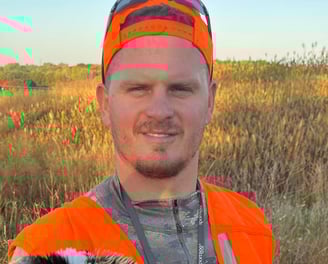 Boss Pressure Washing LLC owner Torsten Boss wearing blaze orange hunting gear outdoors