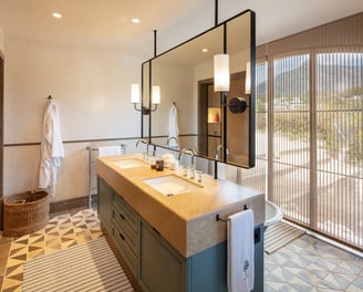 Elegant bathroom at Villa La Gratitud with double vanity, designer lighting, and mountain views.