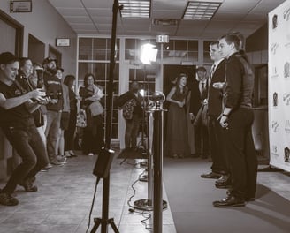 a man standing in front of a microphone and a microphone