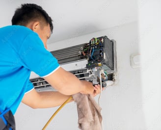 Air Condition Technician Servicing an Aircon Unit System