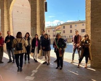 a group of people standing in a line of arches