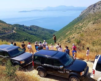 a group of people standing on a hill top
