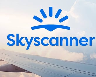 a plane wing wing with the sky and clouds in the background