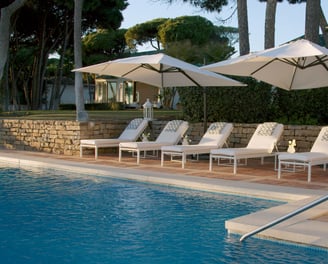 Pool area at Villa El Rincon in Marbella with ocean views, designer furnishings, and open-concept Mediterranean design