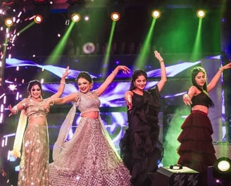 a group of women in traditional indian attire performing a dance