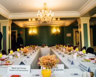 a table with a bunch of plates of food and drinks