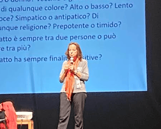 a woman standing on a stage with a microphone and a microphone