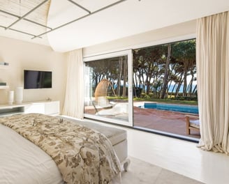 Guest room in the guest house of Villa El Rincon, Marbella, featuring stunning garden and sea views.