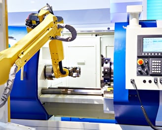 fanuc robot loading a part into a lathe cnc machine