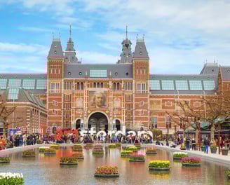 a large building with a fountain in front of a large building